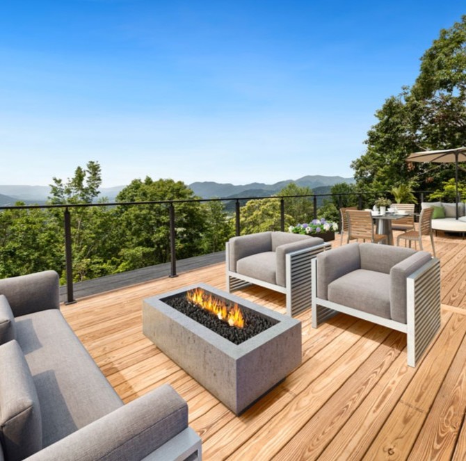 Outdoor deck with fire pit table and mountain view seating area