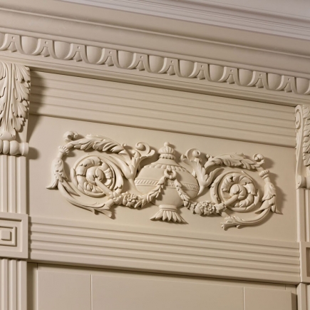 Detail of carved plaster crown molding with an urn motif