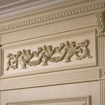Detail of carved wood cornice with an urn and floral swag motif