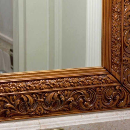 Detail of carved wood mirror frame molding