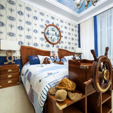 Nautical bedroom with a ship's wheel headboard, sailor-themed bedding, and stuffed animals