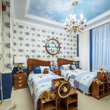 Nautical-themed twin bedroom with a ship's wheel headboard and matching bedding
