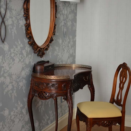 Living room with bay window, classic curtains, sofa, decorative accessories