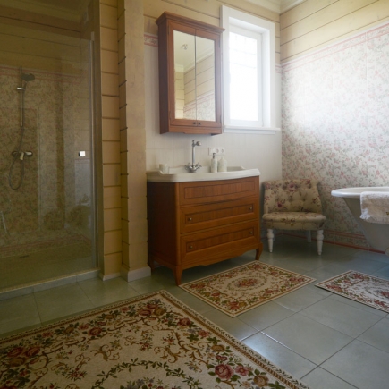 Provençal bathroom with freestanding bathtub and natural stone tiles