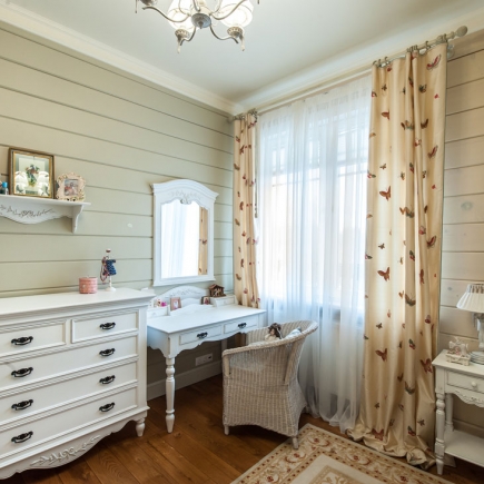 Provençal children's bedroom with white iron bed and floral curtains