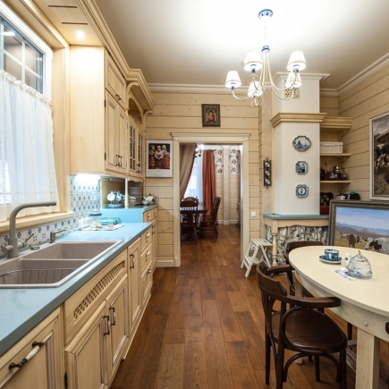 Provençal kitchen interior with white cabinets and stone backsplash