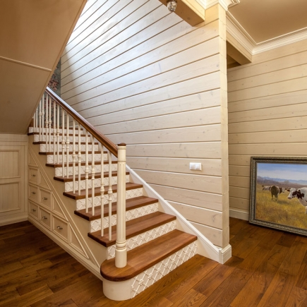 Provençal staircase with wooden handrail and natural stone steps