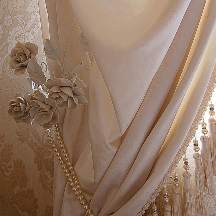 Bedside lamp with a lace-trimmed fabric shade and a porcelain rose base