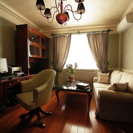 Home office cabinet with a bronze figurine table lamp and a subtle blue LED glow