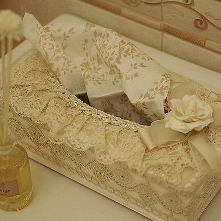 Lace tissue box with a satin rose beside the sink