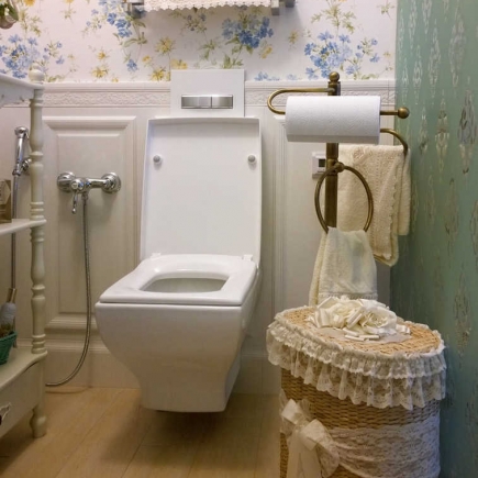Wall-mounted display shelf and console table against damask wallpaper