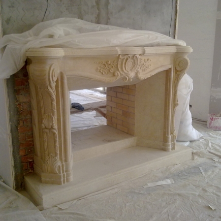 Carved marble fireplace mantel being installed, wrapped in protective covering