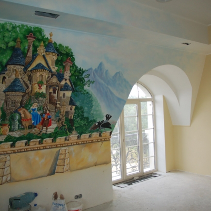 Children's room corner with a hand-painted castle mural beside an arched balcony door