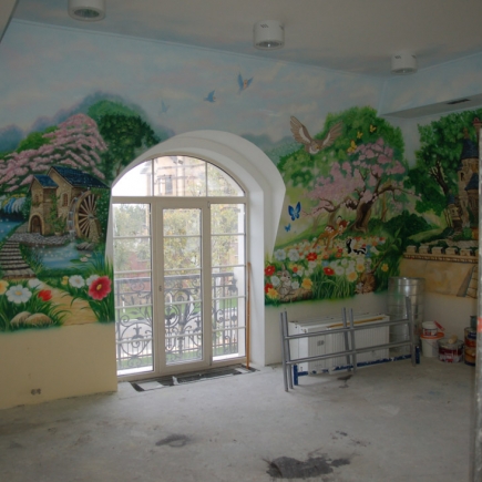 Children's room with a hand-painted fairytale mural surrounding an arched balcony door