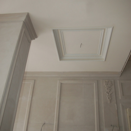 Detail of a recessed ceiling panel with dentil molding during interior finishing