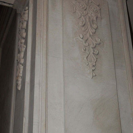 Detail of carved stone pilaster panel with a floral and scroll relief