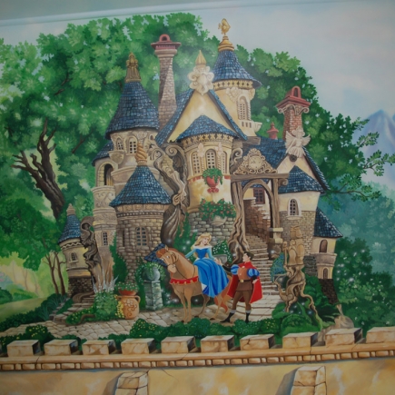 Detail of the hand-painted fairytale castle mural with figures and a horse