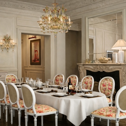 Formal dining room with crystal chandelier, marble fireplace, and floral-upholstered chairs