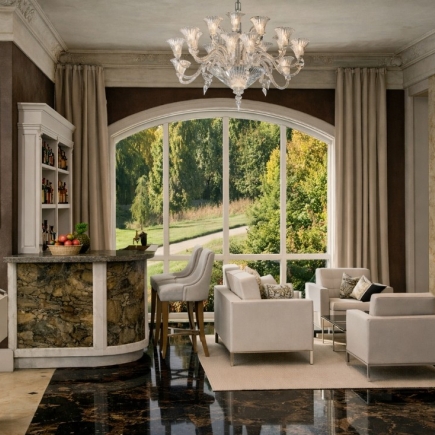 Sitting room with a marble-top bar, arched window, and matching upholstered armchairs