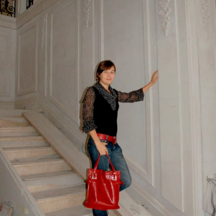 Team member standing on the marble staircase landing during interior finishing
