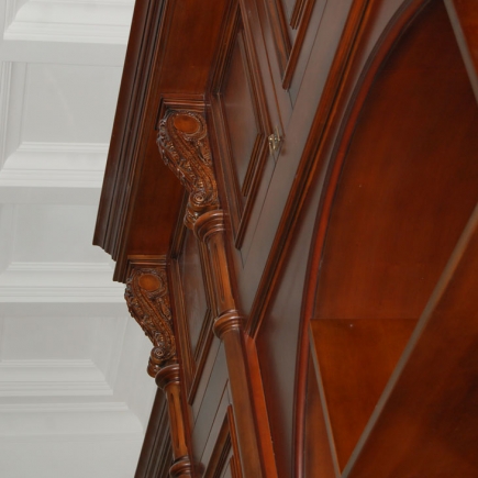 Close-up of the carved mahogany corbel and archway detailing