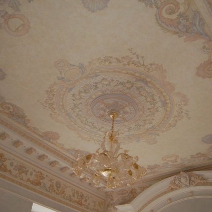 Close-up of the hand-painted ceiling medallion with a crystal chandelier