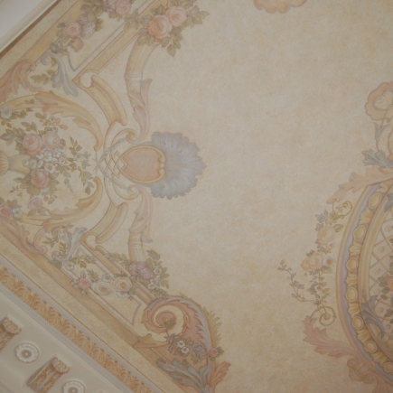 Detail of the hand-painted ceiling fresco with floral garlands and scrollwork