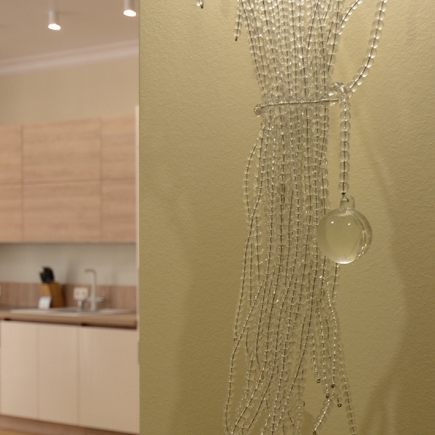 Close-up of a beaded crystal wall decoration with a glass pendant