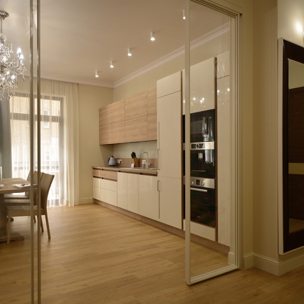 View through the glass sliding partition into the light oak kitchen