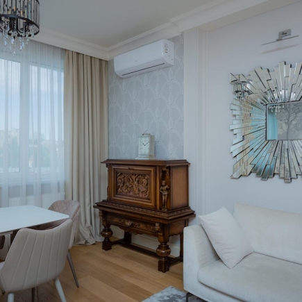 Neoclassical living room with upholstered furniture and decorative moldings
