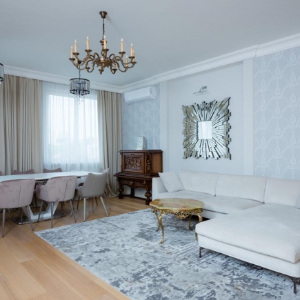 Neoclassical living room with upholstered furniture and decorative moldings