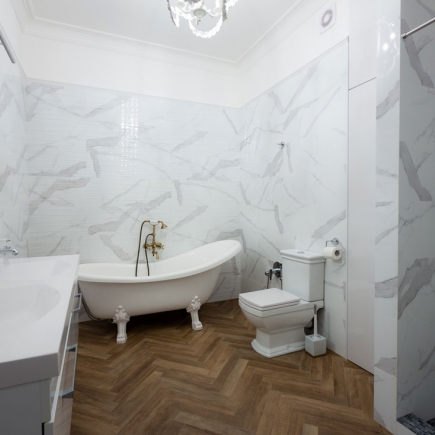Powder room with decorative wallpaper and vessel sink