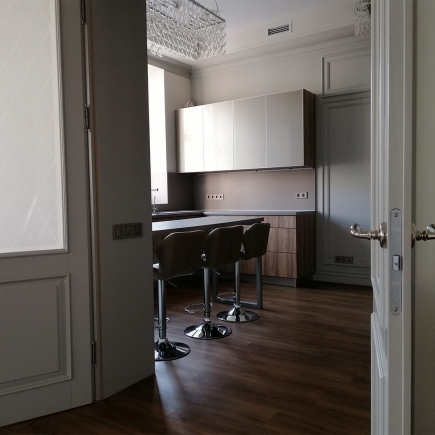 Built-in appliance column with a microwave over an oven in the office kitchenette