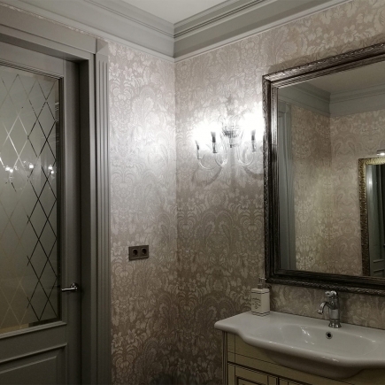 Corridor with grey lattice-glass doors, classical sconces and a chandelier