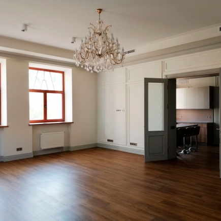 Looking through a doorway into the reception hall with red-framed windows