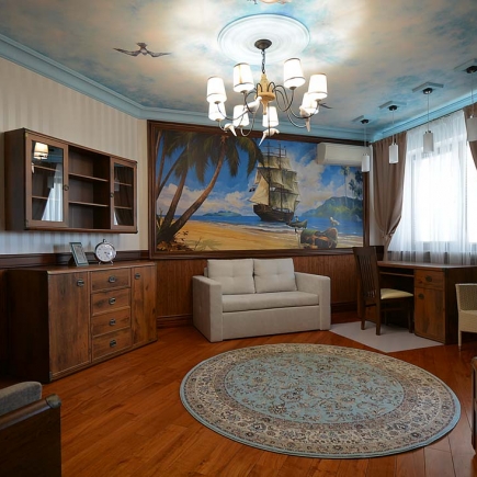 Child's room with a hand-painted pirate ship mural, sky ceiling, and round patterned rug