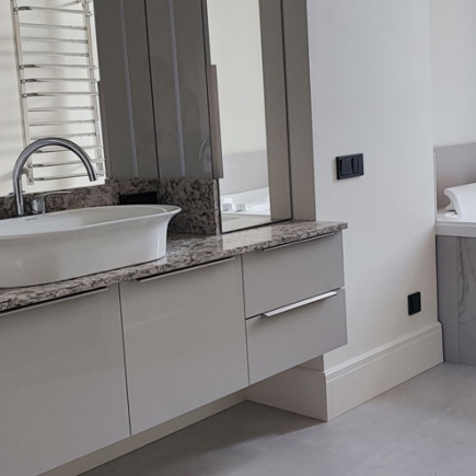 Bathroom vanity with granite countertop and oval vessel sink