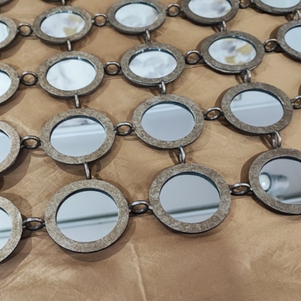 Decorative mirrored disc chain drapery detail