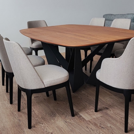 Dining table with wood top, black X-frame base, and upholstered chairs