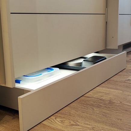 Recessed toe-kick drawer built into the base of the kitchen cabinetry