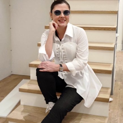 Woman seated on the staircase steps