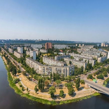 Aerial view of the riverside residential complex and surrounding cityscape