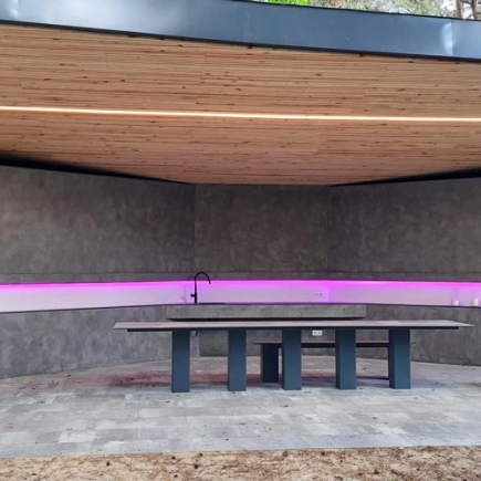 Pavilion interior view centered on the integrated sink and built-in concrete table