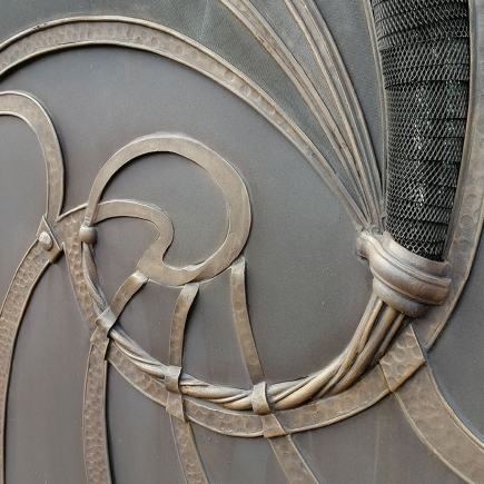 Additional detail of the swirling wrought iron scrollwork on the gate