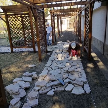 Homeowners reviewing construction plans with the contractor on site