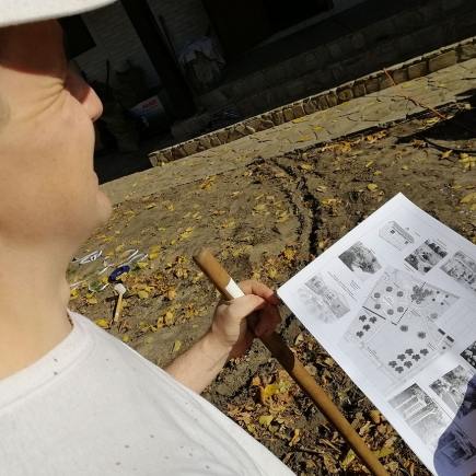 Reviewing a detailed planting layout plan on site