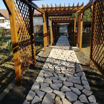 Sunlit view down the finished pergola alley with lattice side panels