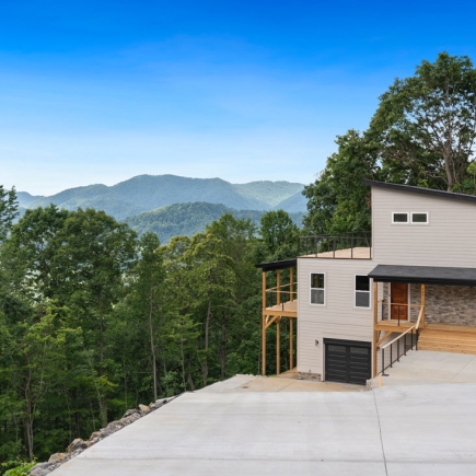 Exterior view of the home and driveway with layered Blue Ridge Mountain views