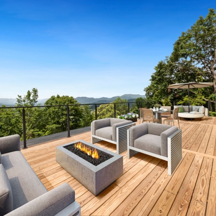 Sun deck with lounge chairs, fire pit table, and mountain views