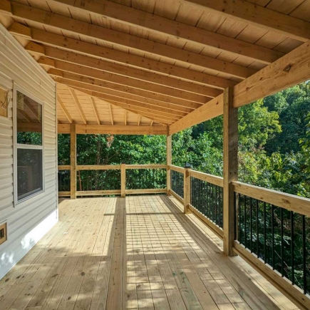 The Blue Ridge House — covered back deck with wood ceiling overlooking the wooded hillside